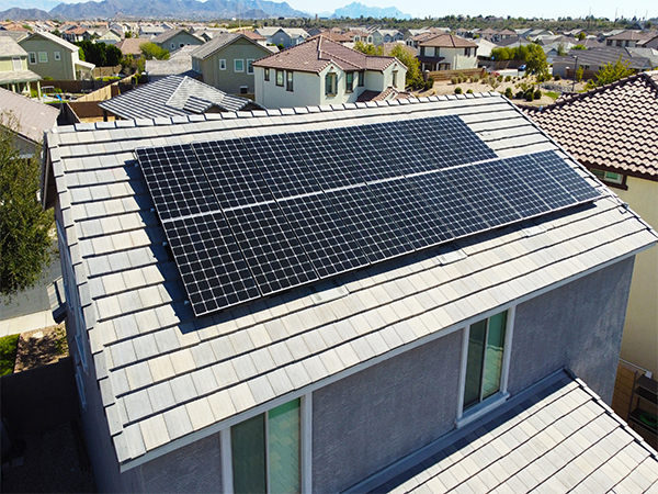 grey house in arizona with solar panels on roof