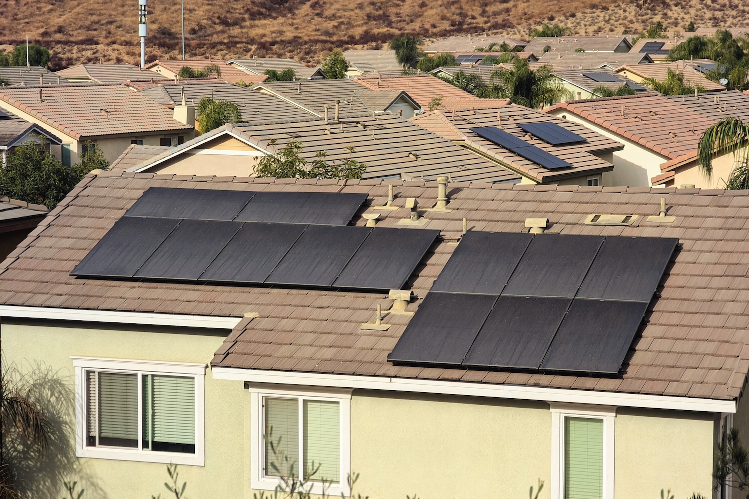 Solar panel array installed on the roofs of two residences