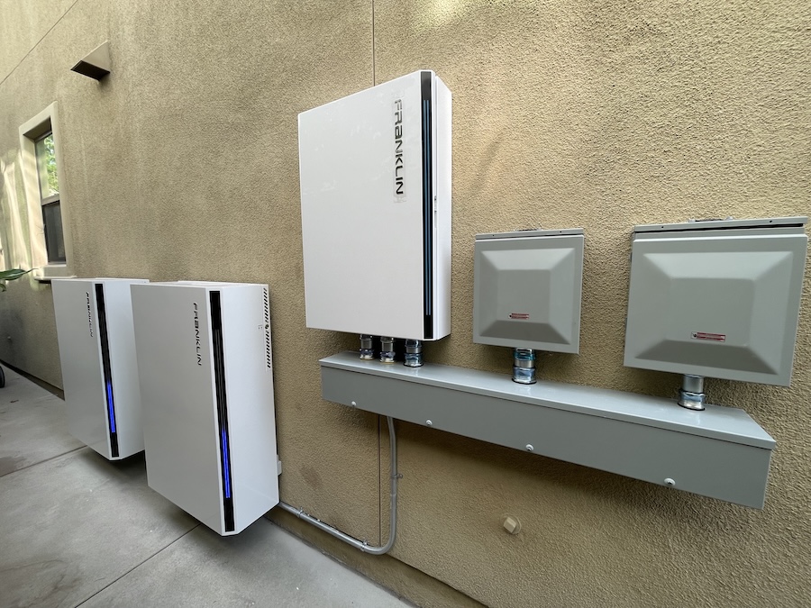 Franklin Powerwall installed on the side of tan building